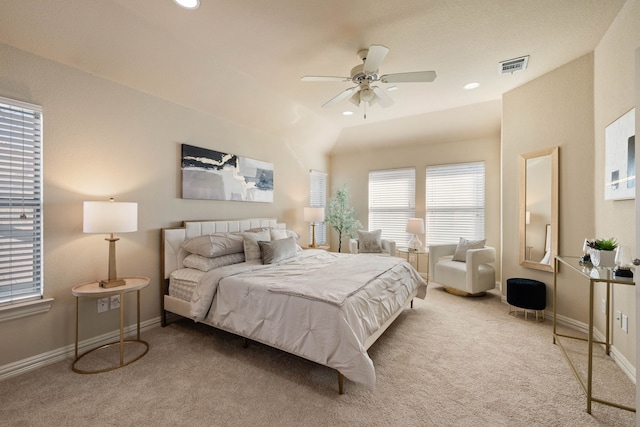 bedroom featuring ceiling fan, vaulted ceiling, and light carpet