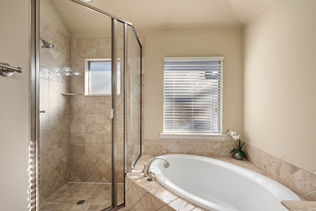 bathroom featuring separate shower and tub and a wealth of natural light