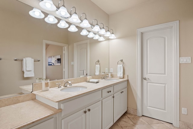 bathroom with vanity, a chandelier, and tile patterned flooring