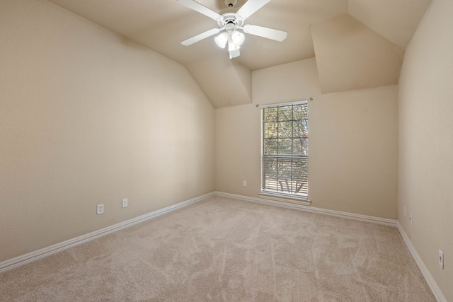 carpeted empty room featuring lofted ceiling and ceiling fan