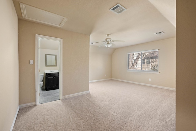 carpeted empty room featuring vaulted ceiling and ceiling fan