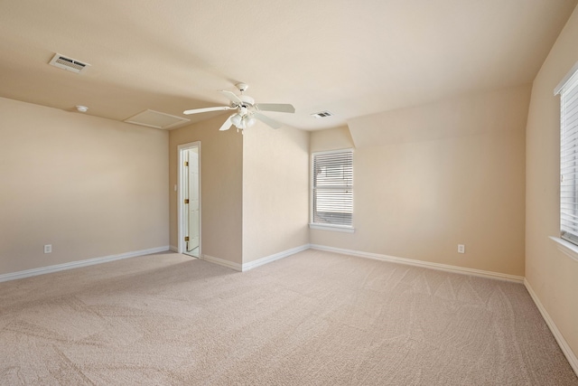 spare room featuring light carpet and ceiling fan