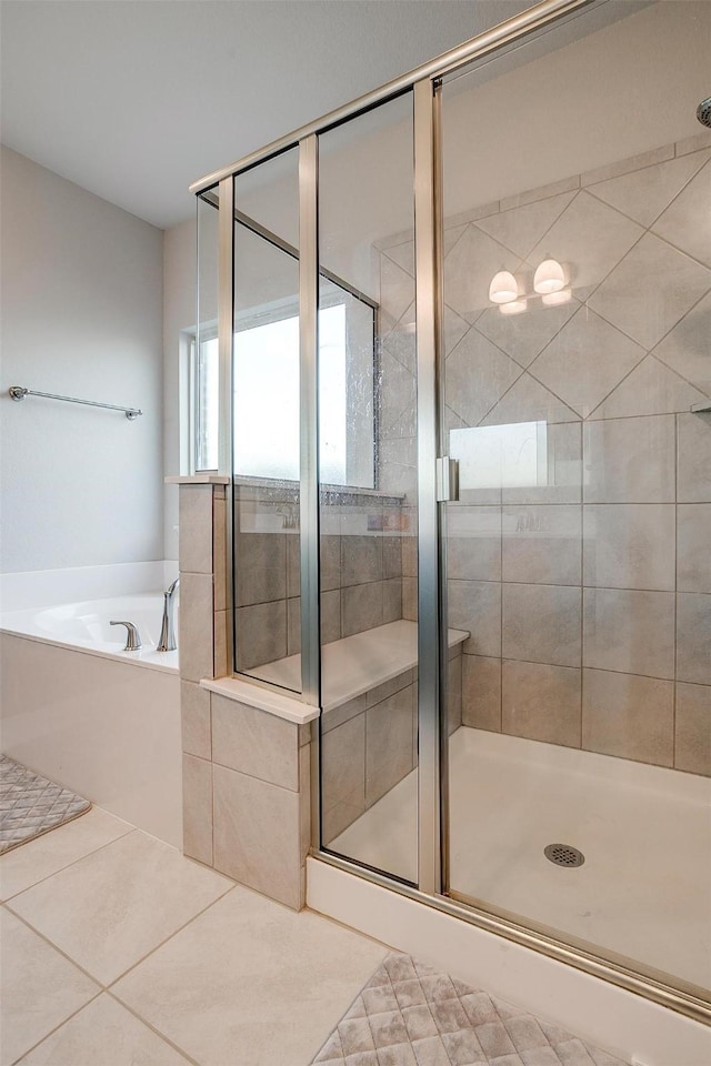 bathroom featuring tile patterned floors and separate shower and tub