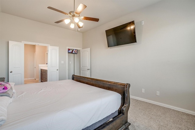 bedroom featuring ensuite bath, carpet floors, and ceiling fan