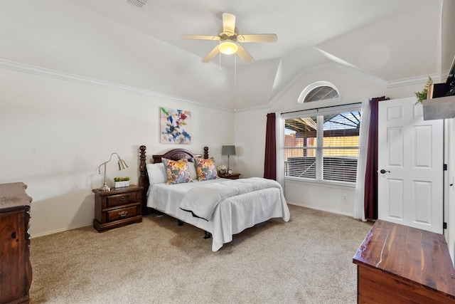 carpeted bedroom featuring ceiling fan, ornamental molding, and vaulted ceiling