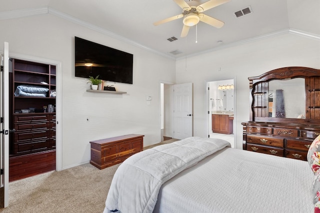 bedroom with lofted ceiling, connected bathroom, crown molding, light carpet, and ceiling fan