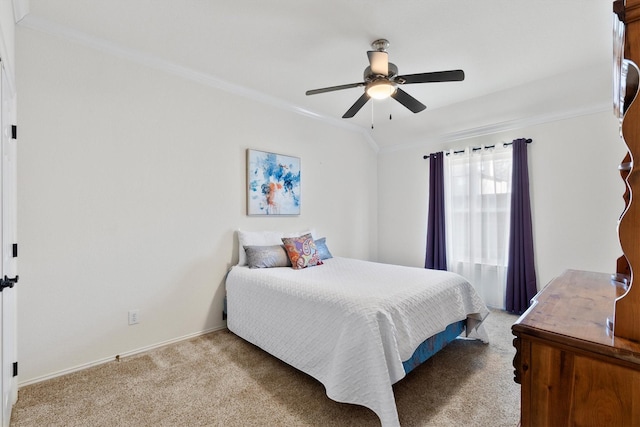 carpeted bedroom featuring crown molding and ceiling fan