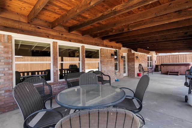 view of patio featuring outdoor dining space and a hot tub