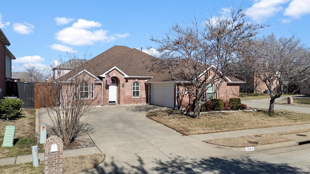 ranch-style house featuring brick siding, a shingled roof, fence, concrete driveway, and an attached garage