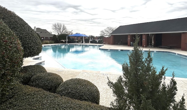 view of swimming pool featuring a gazebo and a patio