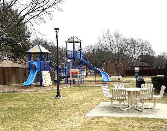 community playground with a lawn and fence