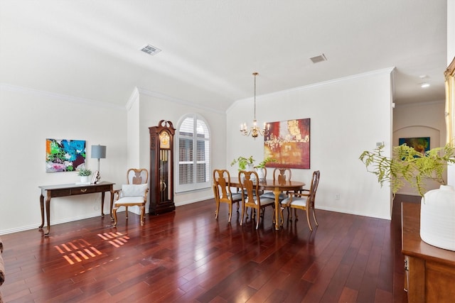 dining area with ornamental molding, dark hardwood / wood-style floors, and a notable chandelier