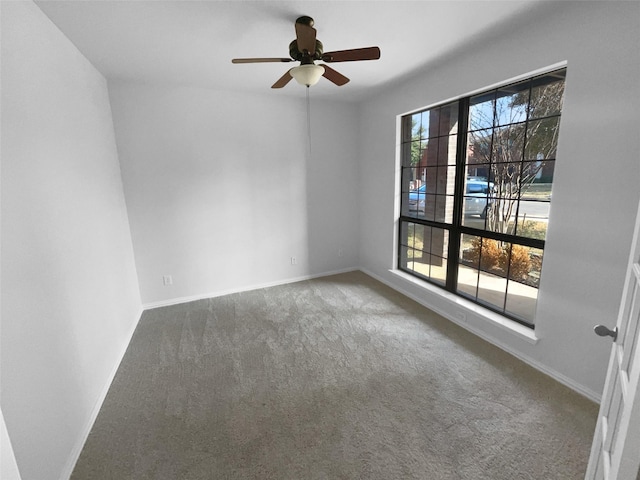 spare room featuring carpet flooring and ceiling fan