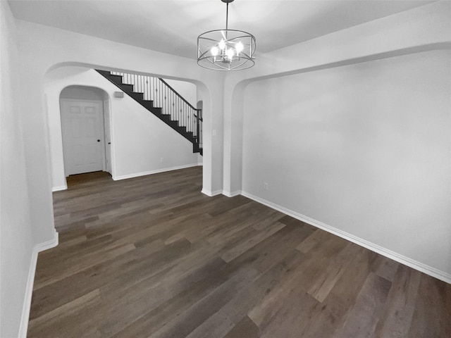 interior space featuring dark hardwood / wood-style flooring and a notable chandelier