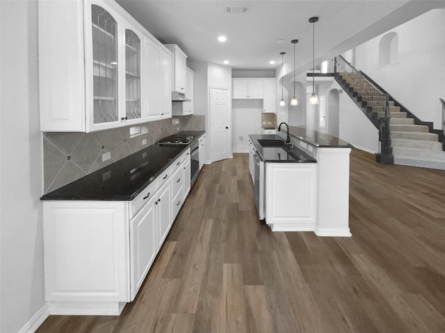 kitchen featuring decorative light fixtures, sink, white cabinets, backsplash, and stainless steel appliances