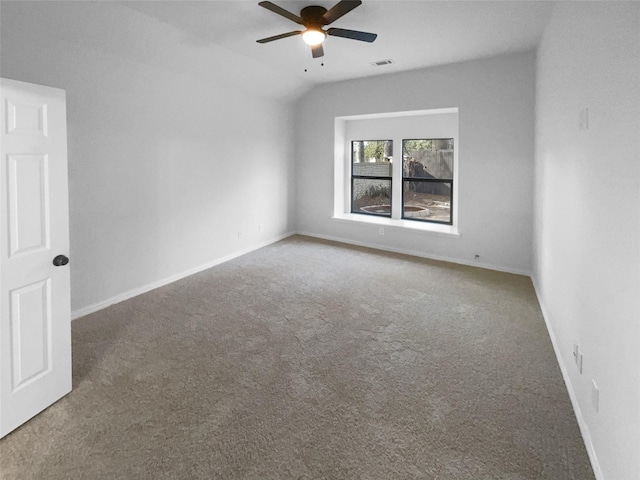 spare room featuring ceiling fan, lofted ceiling, and carpet