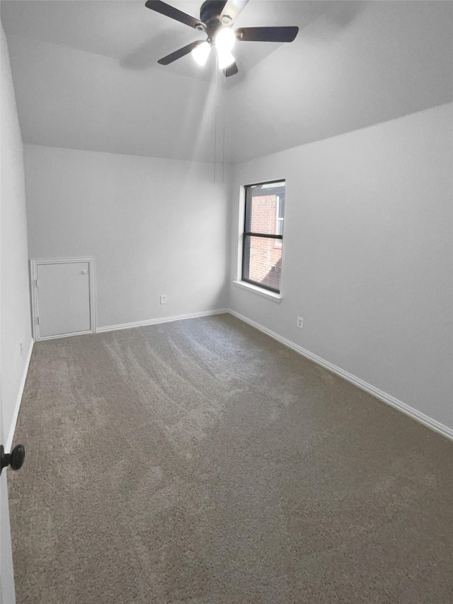 interior space featuring vaulted ceiling, carpet floors, and ceiling fan