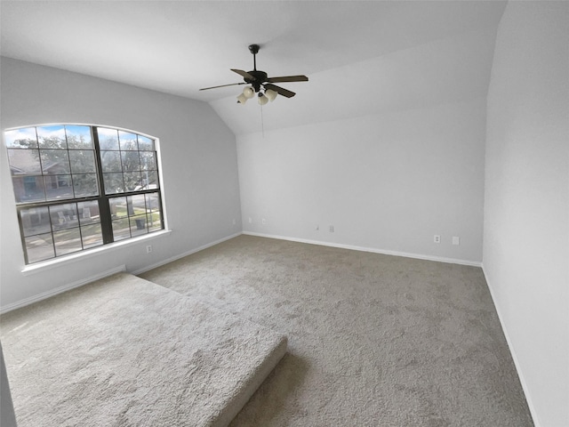 carpeted empty room with lofted ceiling and ceiling fan