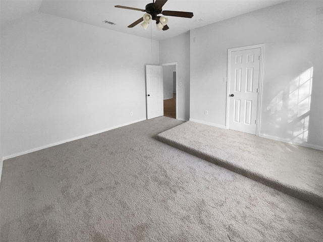 carpeted spare room featuring ceiling fan