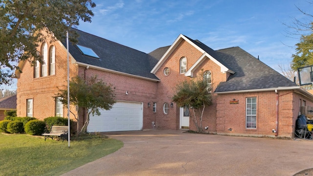 view of front of house with a garage and a front lawn