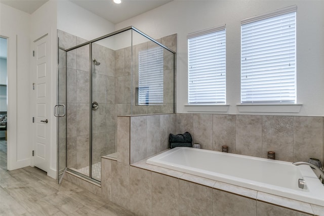 bathroom with separate shower and tub