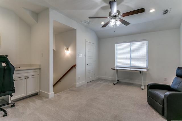 living area featuring light carpet and vaulted ceiling