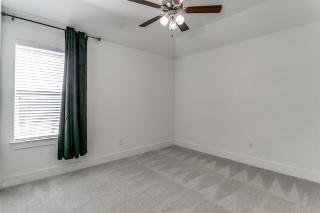 unfurnished room featuring vaulted ceiling, light colored carpet, and ceiling fan