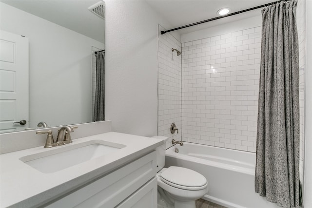 full bathroom featuring vanity, shower / bath combination with curtain, and toilet