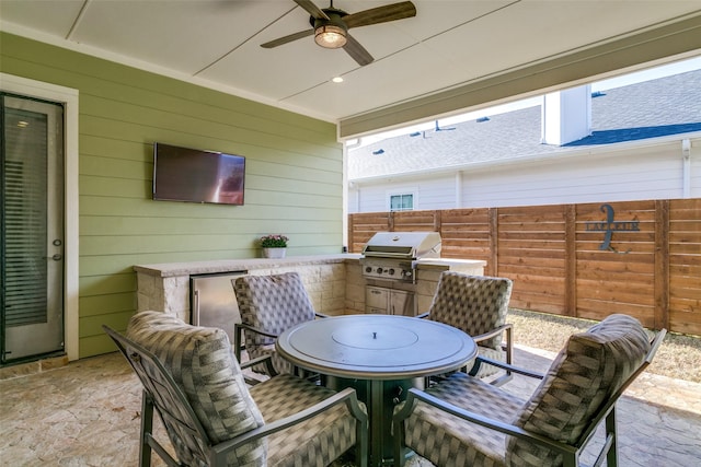 view of patio featuring area for grilling, grilling area, and ceiling fan