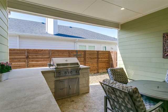 view of patio with area for grilling and an outdoor kitchen