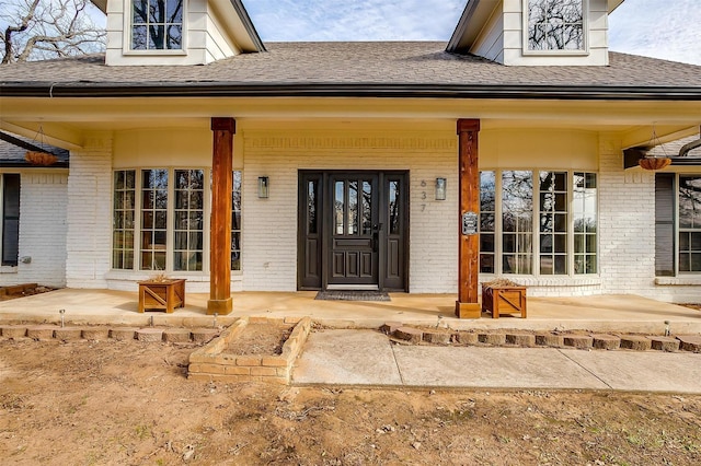 view of exterior entry with covered porch