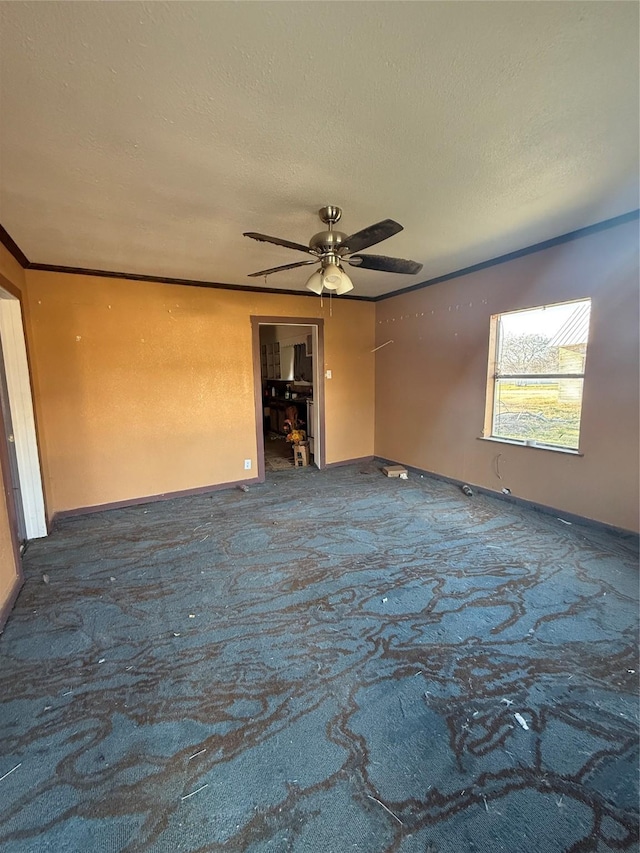 spare room featuring ceiling fan, crown molding, carpet floors, and a textured ceiling