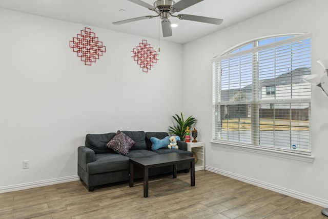 living area featuring ceiling fan and light hardwood / wood-style flooring