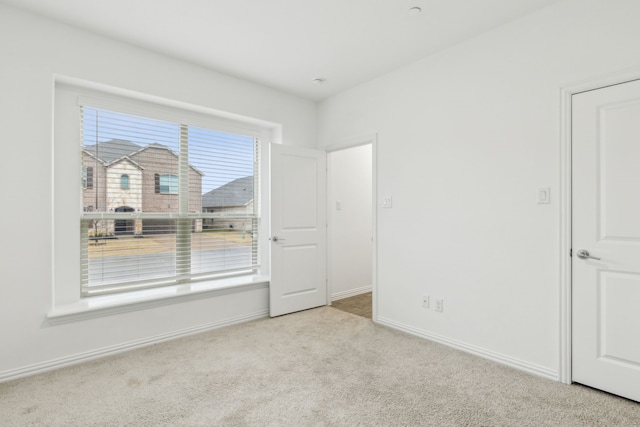 empty room with light colored carpet