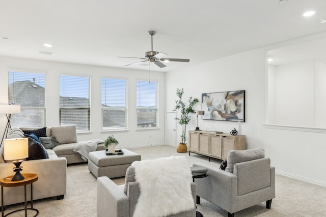 living room with light colored carpet and ceiling fan