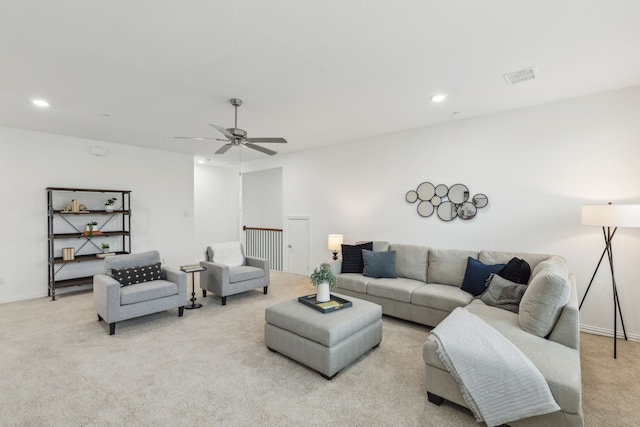 living room featuring light carpet and ceiling fan