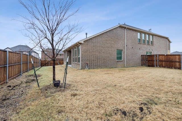 rear view of house featuring a yard