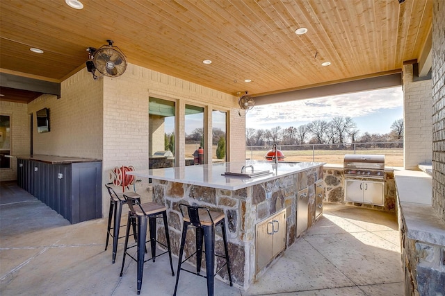 view of patio / terrace with exterior bar and grilling area