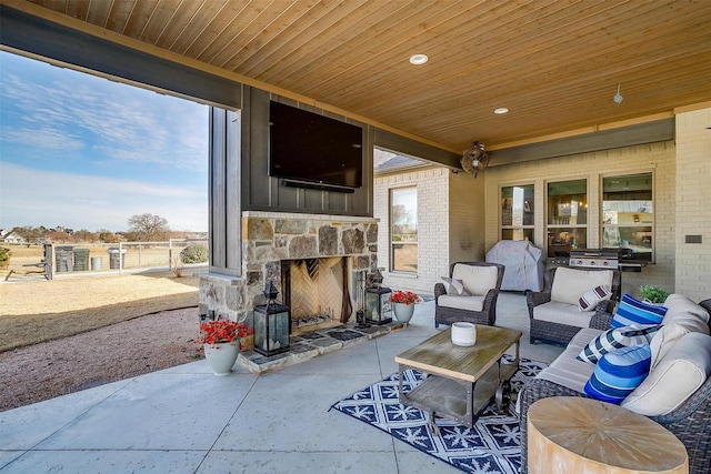 view of patio with an outdoor stone fireplace