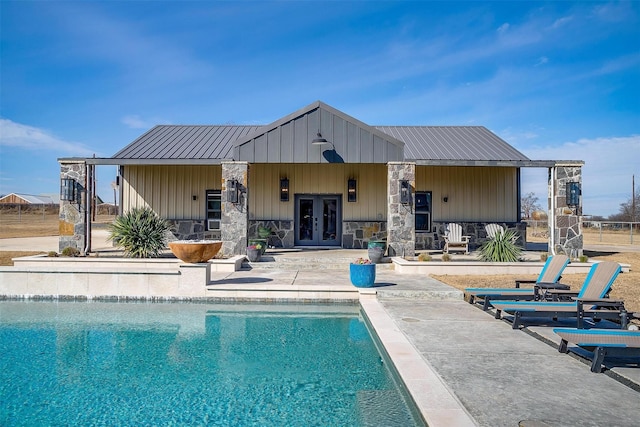 view of pool with a patio and french doors