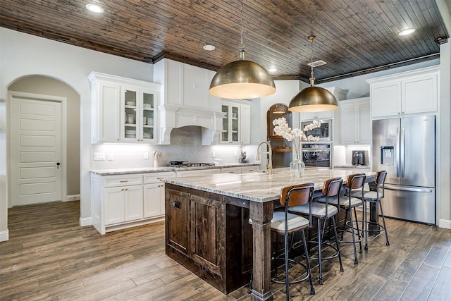 kitchen featuring white cabinetry, appliances with stainless steel finishes, and a kitchen island with sink