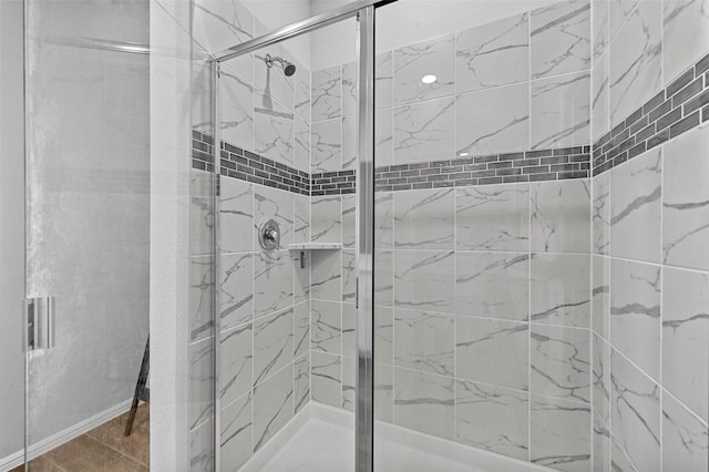 bathroom featuring a shower with door