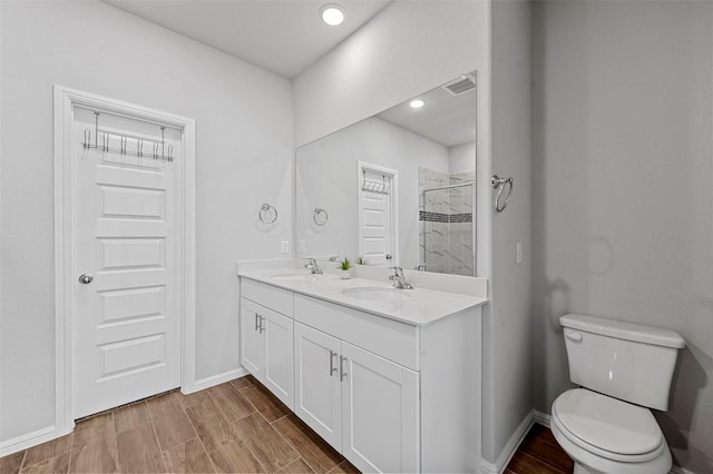 bathroom with vanity, toilet, and a shower with shower door