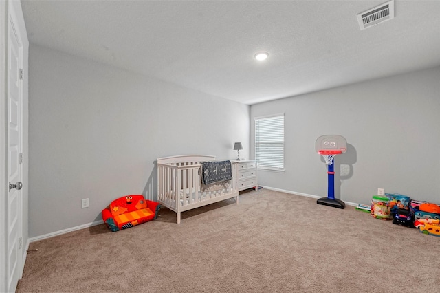 bedroom with carpet flooring and a crib