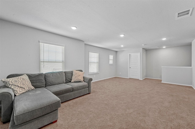 carpeted living room with a textured ceiling