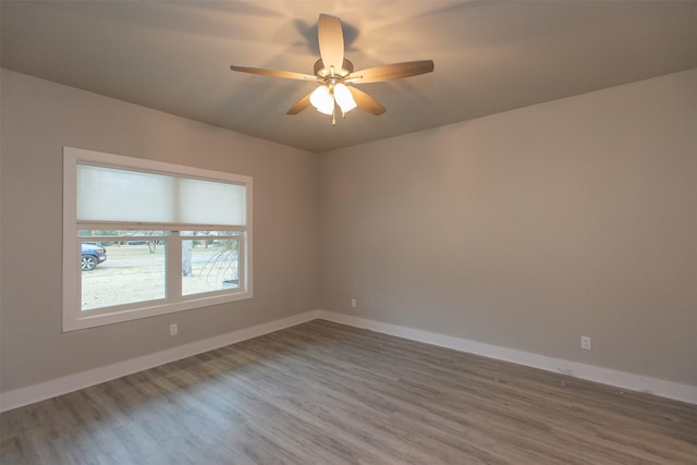 spare room featuring hardwood / wood-style flooring and ceiling fan