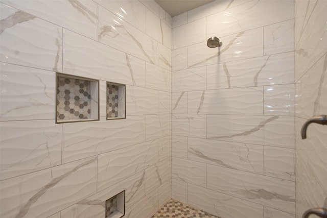 bathroom with tiled shower