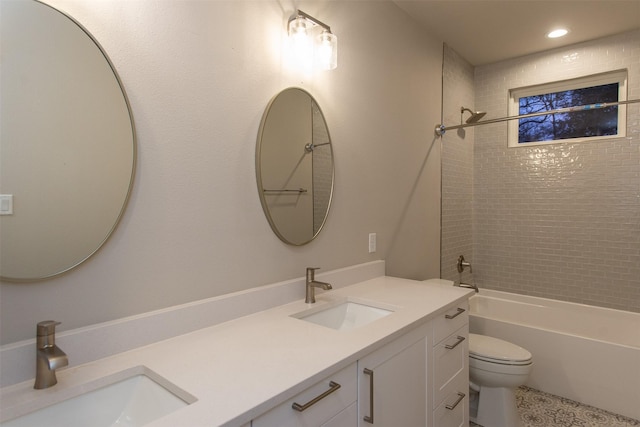 full bathroom featuring vanity, toilet, and tiled shower / bath combo