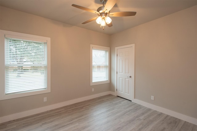 spare room featuring ceiling fan and light hardwood / wood-style floors