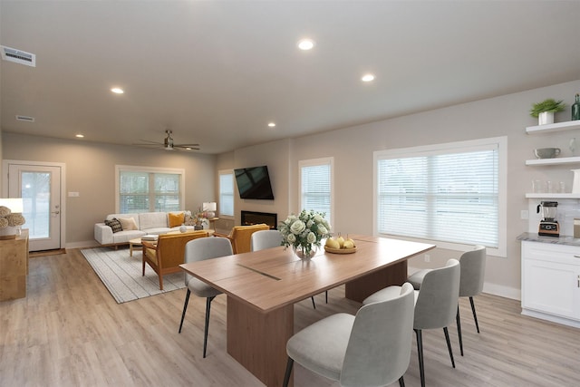 dining room with ceiling fan and light wood-type flooring